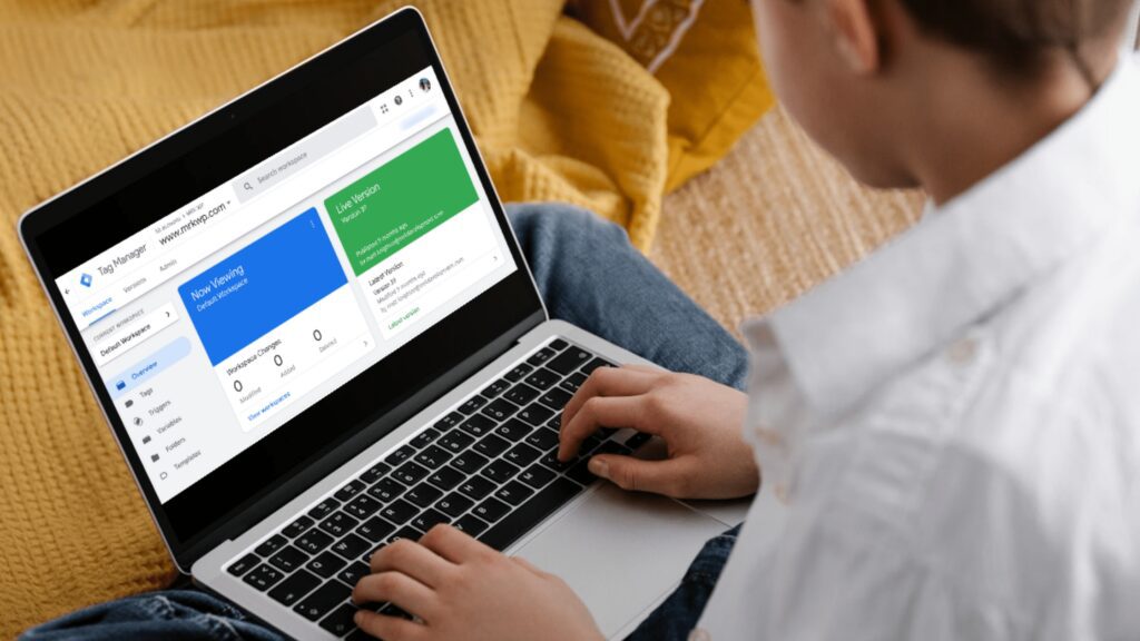 A boy viewing the Google Tag Manager dashboard on a laptop.